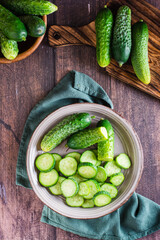 Fresh sliced cucumbers on a plate on the table. Dietary organic food. Top and vertical view