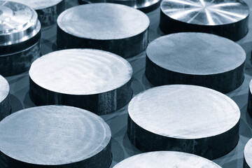 background from round metal billets cutted in workshop, industrial background