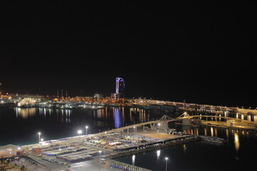 Night Panoramic view of barcelona and cargo port in spain
