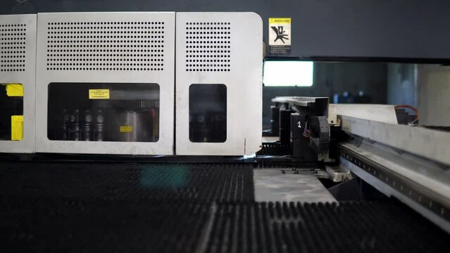 Metal punching machine at a modern industrial factory. Making the dealer on the CNC with a stamping machine