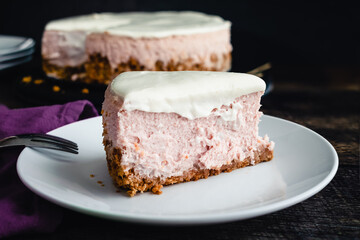 Slice of Honey Lavender Cheesecake Side View: Slice of pastel colored cheesecake on a plate with a fork