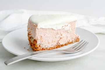 Slice of Honey Lavender Cheesecake Closeup: Slice of pastel colored cheesecake on a plate with a fork