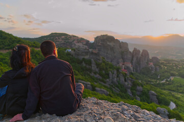 Naklejka premium Couple on the Top of Mountain at Sunset. Greece, Meteora. close up