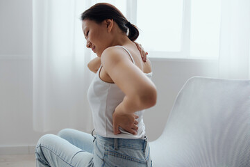 Suffering from scoliosis osteochondrosis after long study pretty young Asian woman feel hurt joint...