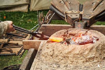 Work of a medieval blacksmith for the manufacture of metal products. Reconstruction of the events...