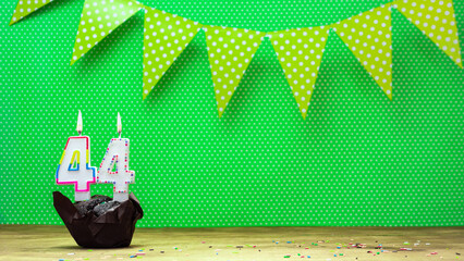 happy birthday with decorations festive garlands with muffin on a green background with polka dots....