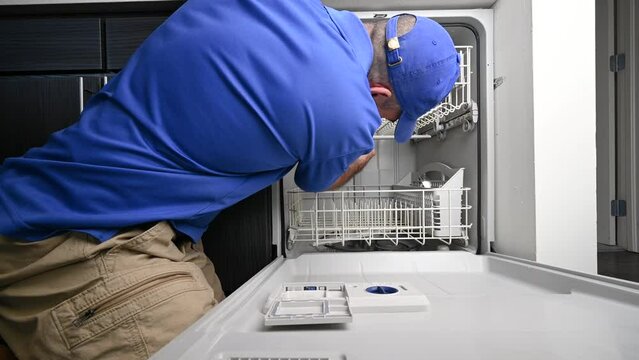 Appliance Technician Installing a Spray Arm on Dishwasher