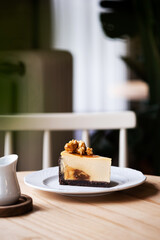 caramel cheesecake with popcorn and salted caramel sauce on white plate, selective focus