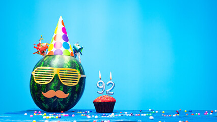 Creative happy birthday greeting with muffin festive garlands decoration. Fan greeting card. Copy space. Beautiful happy birthday background with burning candles with number 92