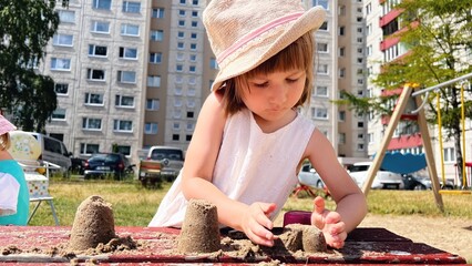 SMALL GIRL playing at playground at backyard of blocks of flats