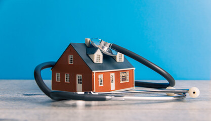 House and Stethoscope on Table