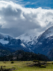 Fototapeta na wymiar Mountain landscape with snow-capped peaks and dramatic clouds, Rocky Mountain National Park