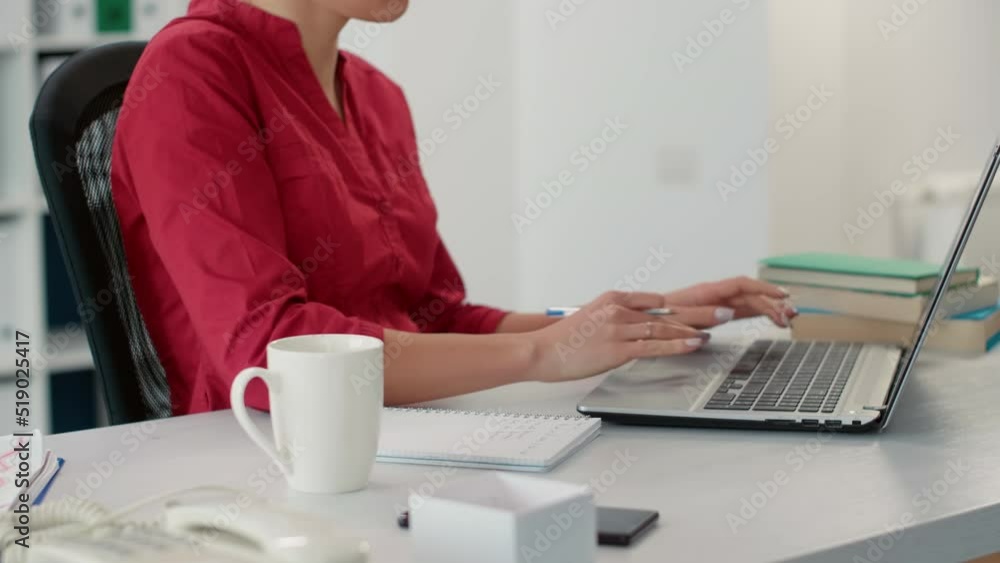 Poster company accountant using sales report to take notes on notebook, planning financial development with