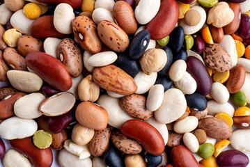 many dried multi-colored beans closeup, an assortment of various kidney beans and peas