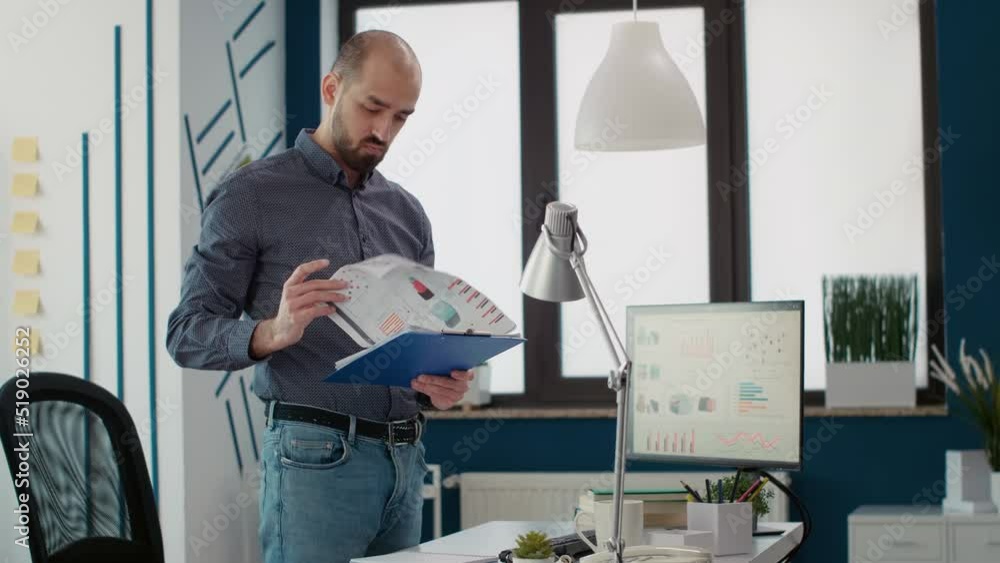 Aufkleber company accountant analyzing marketing report on documents, using financial statistics with data cha
