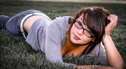 Beautiful, sexy, lady laying in the grass