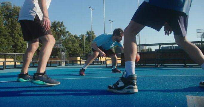 Young man tries to outplay players to score ball closeup