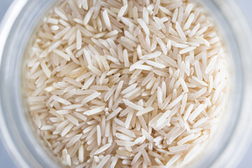 glass jar with basmati rice close-up shot from top down perspective, healthy pantry ingredients