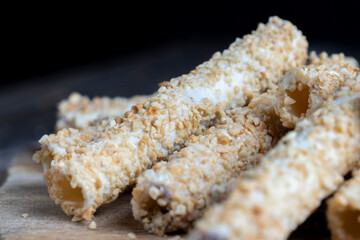 waffle tube with chocolate filling and crushed peanuts
