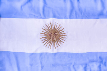 Top View of Argentina Ceremonial flag with embroidered sun in gold threads in the center.