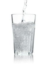 Pouring soda water into glass on white background