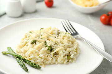 Delicious risotto with asparagus in plate, closeup