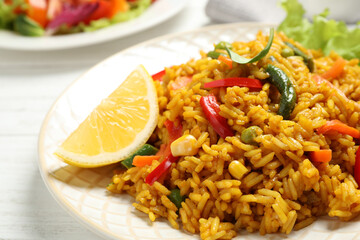 Delicious rice pilaf with vegetables on white table, closeup