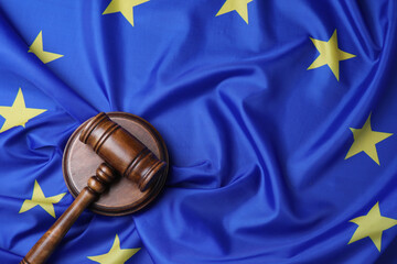 Wooden judge's gavel on flag of European Union, top view. Space for text
