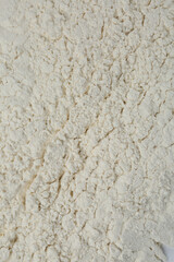 Pile of organic flour as background, top view