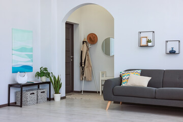 Beautiful living room interior with stylish grey sofa