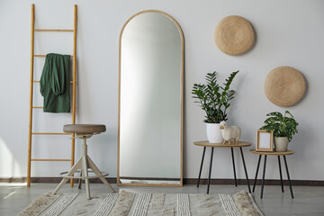 Stylish room interior with leaning floor mirror - Powered by Adobe
