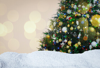 Beautifully decorated Christmas tree and snow on light background, space for text. Bokeh effect