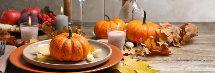 Beautiful autumn place setting and decor on wooden table. Banner design