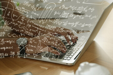 Science and education concept. Illustration of basic physics and mathematics formulas and man working on laptop at table, closeup