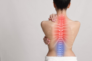 Woman suffering from pain in neck on light background, space for text - obrazy, fototapety, plakaty