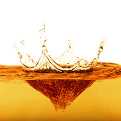 Fototapeta na wymiar Golden oily liquid splash on white background