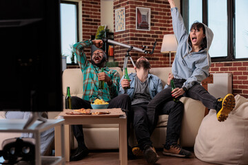 Sport supporters celebrating football match victory, feeling happy about team scoring goal and winning soccer game tournament. Group of fans enjoying championship win, drinking beer.