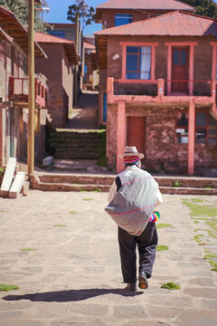 Native man walking on Taquile island, Puno, Peru