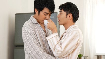 Two best friends LGBTQ relation partner home cooking. Happiness romance homosexual marriage lifestyle. Two men together love friendship. Happy gay couple enjoy breakfast in kitchen drinking coffee