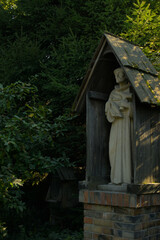 Fototapeta na wymiar Old mystical altar witha statue in the woods
