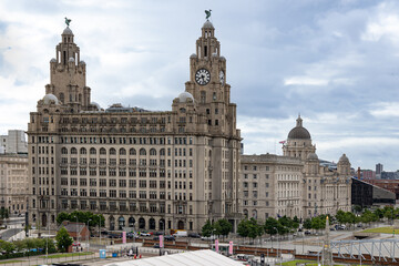 Naklejka premium Buildings on the Liverpool waterfront skyline known as The Three Graces. The Royal Liver Building, The Cunard Building and the Port of Liverpool Building.