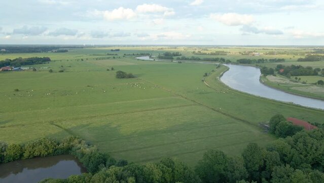 Flying Towards Verdant Landscape With River Leda Near Schloss Evenburg In Leer, Germany. Aerial Wide Shot
