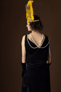 1920s Woman Wearing An Evening Gown And A Head Band With A Large Feather