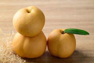 Asian pear or Nashi pear on wooden background