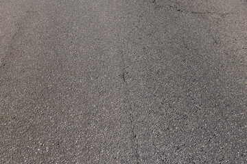a highway with oil stains and cracks