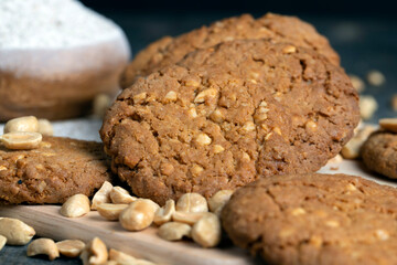 oatmeal cookies with peanuts on a black wooden table