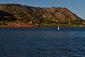 Fototapeta premium Rocky and Rough Shoreline of Lake Meredith in the Texas Panhandle near Amarillo, Summer f 2022.