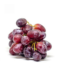 Purple fresh and wet grapes on white background