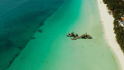 Travel concept: sandy tropical beach with hotels and tourists near the blue lagoon, aerial view, Boracay, Philippines. Seascape with beach on tropical island. Summer and travel vacation concept.
