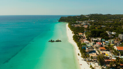 Tropical beach with tourists and clear blue sea, top view. Summer and travel vacation concept. Boracay, Philippines